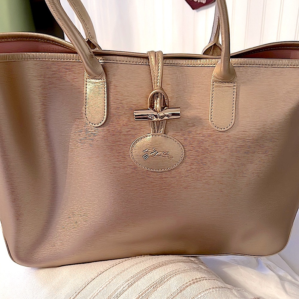 Beautiful Longchamp tote gold with pink interior!